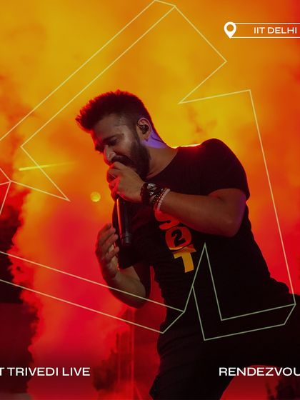 Amit Trivedi Live at Rendezvous X, surrounded by dramatic red smoke and lighting.