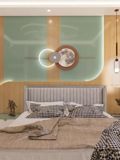 This bedroom features a mint green and wood accent wall with a moon-themed art piece and stylish pendant lights.