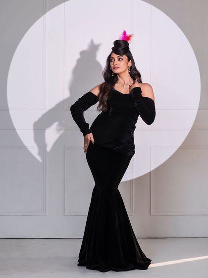 A full-length shot showcasing an innovative hairstyle that looks like a hat, paired with a classic black gown. This demonstrates our studio's capacity for creative and avant-garde fashion shoots.