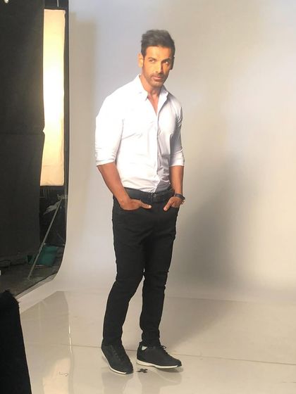 Styling John Abraham for a photoshoot. A crisp white shirt and black trousers is a classic combination that never fails.