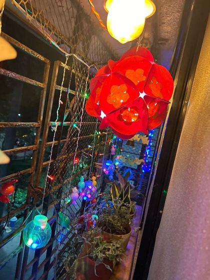A handmade lantern glowing beautifully at night. It's so special for kids to see their own creations become part of their family's Diwali decorations.