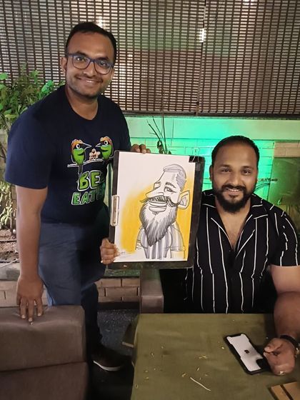 Here I am with a guest and his caricature at Mountain High.