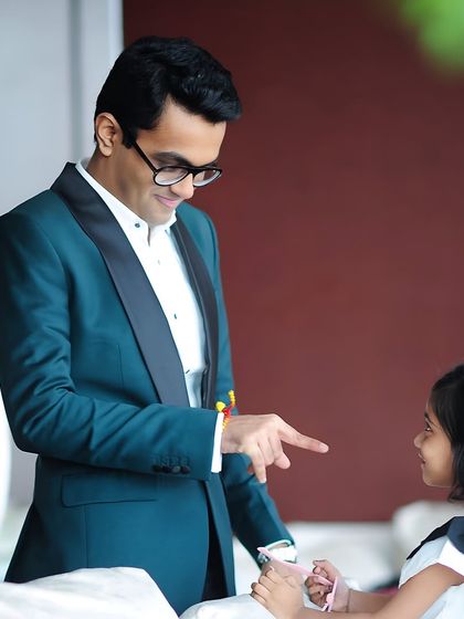 A playful moment between a father and daughter, with him dressed in our deep green tuxedo. It’s a testament to how a great outfit can make you feel confident and joyful.