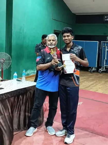 Yashwin Gade receives his trophy for a third-place finish in the U-19 boys' category at the 2nd District Ranking tournament.