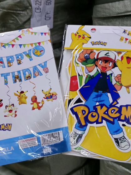 I stock supplies for Pokémon-themed parties, including Happy Birthday banners and character cutout sets featuring Ash and Pikachu.