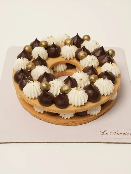 I love creating these custom Cream Tart Cakes for your special milestones. This one, shaped as a letter 'O', has a crunchy biscuit base layered with vanilla mascarpone mousse and rich Belgian chocolate ganache.
