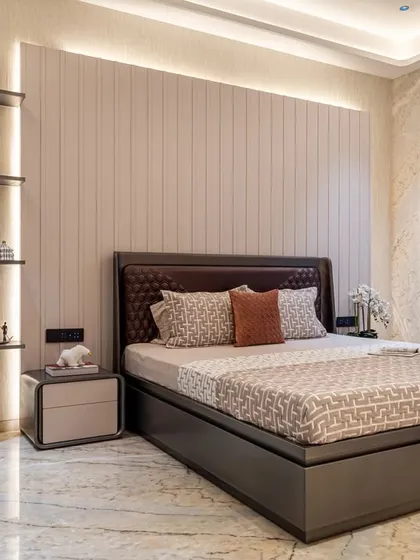 In this bedroom, we paired a classic houndstooth armchair with a sleek, modern bed and backlit shelving. The design is a study in contrasts, blending bold patterns with minimalist forms for a sophisticated look.