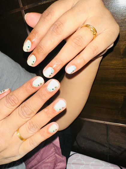 Another view of the minimalist dot art on natural nails, perfect for a subtle pop of color.