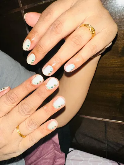 Another view of the minimalist dot art on natural nails, perfect for a subtle pop of color.
