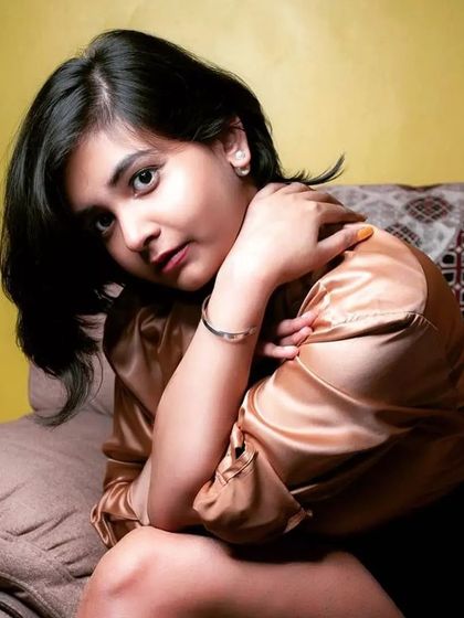 A woman in a satin shirt models a silver cuff bracelet, showing how its simple elegance can elevate any outfit.