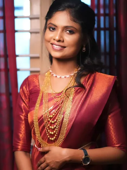 A candid shot of the bride, looking happy and radiant. Her makeup is subtle and long-lasting, designed to look perfect throughout the entire event.