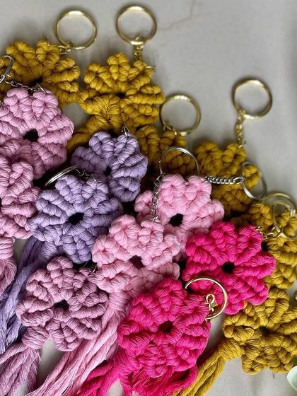 A pile of colorful flower keychains. It's a garden of macrame!