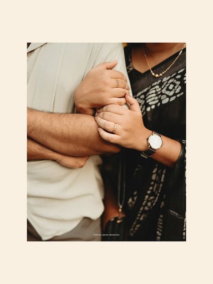 A close-up detail shot of the couple's hands, symbolizing their connection and the beginning of their journey together.