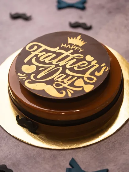 A special cake designed just for Father's Day. This coffee and chocolate creation has a rich, glossy finish and is topped with a custom "Happy Father's Day" chocolate plaque.