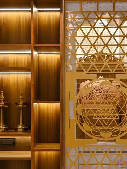 A tranquil corner for prayer and meditation. We designed this pooja unit with intricate geometric jali work on the door, which is beautifully highlighted by warm, integrated LED lighting. The wooden shelves provide ample space for idols and traditional lamps.