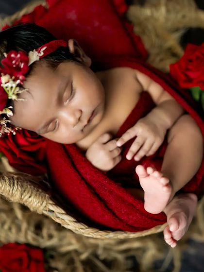 A close-up of this sleeping beauty, showing off her tiny features and the beautiful red floral headband.
