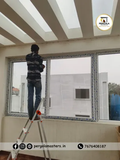 Our team is equipped to handle installations in any part of your home, including elevated areas. A technician on a ladder completes the final adjustments on a newly installed UPVC window, ensuring every detail is perfect from top to bottom.