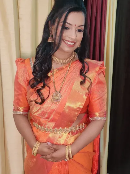A beautiful South Indian bridal look. I gave her a deep nude lipstick and shimmery gold eyes to complement her gorgeous dual toned orange and pink Kanjeevaram saree.