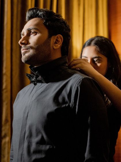 A candid moment of the groom getting ready with his family. Our styling extends to the entire family, ensuring everyone looks their best for the cocktail party.