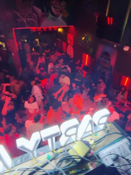 An overhead view of the packed dance floor at Blurred X Party Monkeyz, lit in a dramatic red hue.