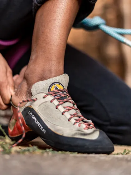 Lacing up for a climb. The right pair of shoes can make a huge difference, and we help you find a comfortable fit from our gear library.