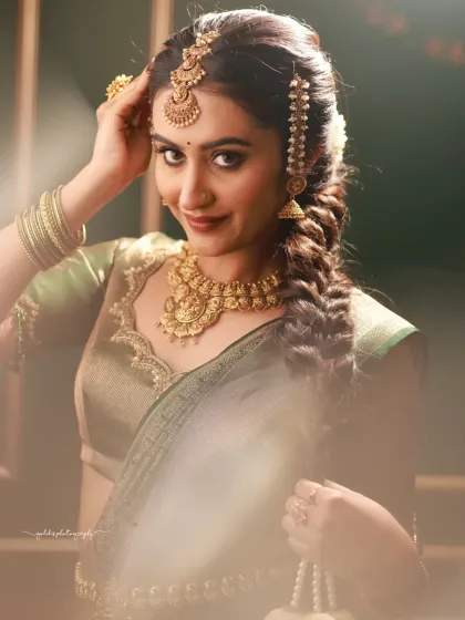 Indoor portraits of a model in a dark green silk saree. The elegant posing, reflection in the mirror, and studio setup with a classic red sofa create a sophisticated and polished look.