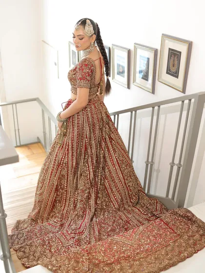 The trail of this bridal lehenga is a masterpiece in itself. As the bride walks up the stairs, you can see the full extent of the intricate embroidery that covers every inch.