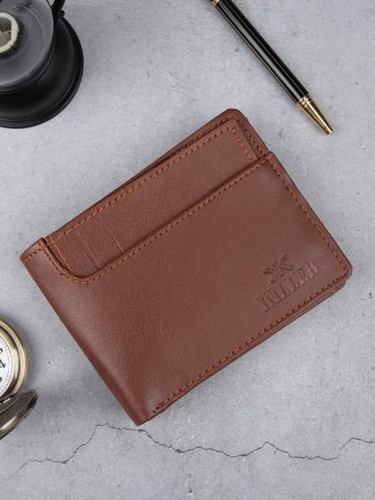 A styled shot of a brown wallet with a pocket watch and pen, creating a professional and classic vibe.