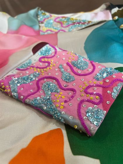 Starting the week with a splash of colors. This blouse features abstract, multi-colored sequin embroidery on the collar and cuffs.