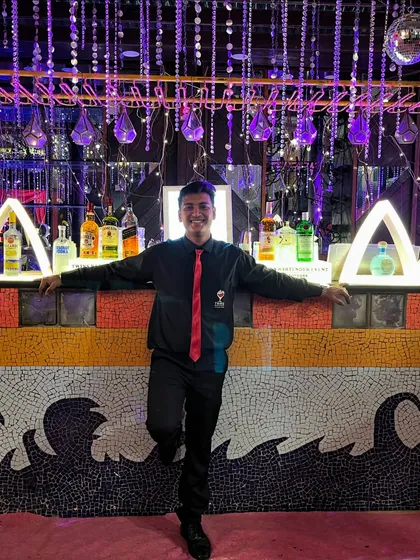 Taking a moment to pose at the stunning mosaic-tiled bar. We take pride in our presentation and ensure our bartenders and the bar itself look sharp and professional.
