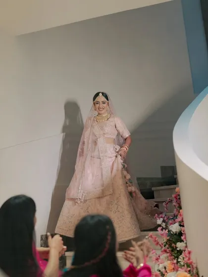 The bride's grand entrance down a spiral staircase. This is a stunning, dramatic shot that captures a key moment of the day.