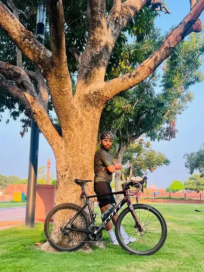 A moment of quiet reflection. A rider and his Scott bike under a tree.