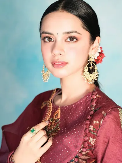 Another beautiful shot of Nitanshi Goel, this time wearing a different ring with a Zambian emerald and ornate gold earrings.