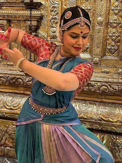 Another capture from our tour, this time in a beautiful blue and green silk costume against a traditional temple backdrop. The setting often inspires the performance, adding another layer of meaning to the dance.
