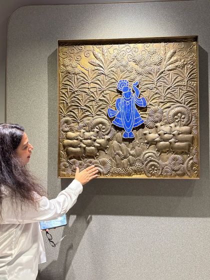 Here I am with a beautiful piece of brass wall art depicting Lord Krishna. Integrating traditional Indian art forms is one of my favorite ways to add soul and a deep cultural connection to a modern home.