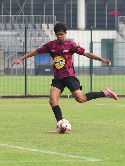A player strikes the ball with perfect form, showcasing the results of dedicated training.