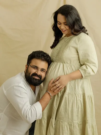 "I can't wait to meet you." This classic pose of a partner listening to the baby bump is always so sweet and full of anticipation. A beautiful memory from your casual studio session.