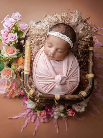 This overhead shot in a basket shows how I use layers of soft fabrics and flowers to create a beautiful, nest-like setting for your baby.