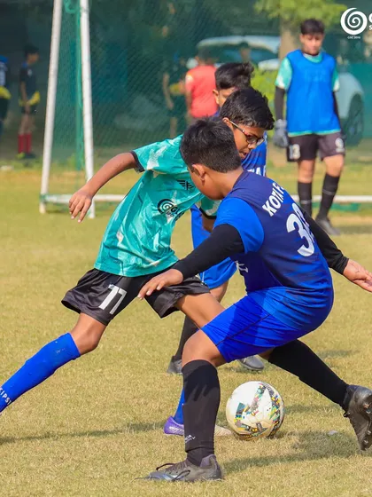Two players challenge for the ball, demonstrating the competitive nature of the Pride Cup.