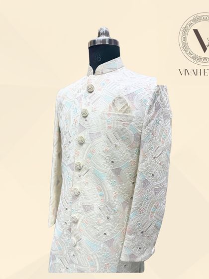 Another look at our ivory sherwani, showcasing its flawless tailoring and the beautiful drape of the fabric. We ensure you look perfect from every angle.