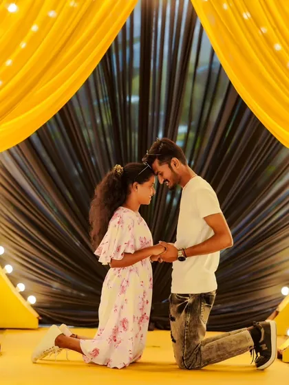 A romantic and tender moment in front of a dramatic yellow and black backdrop. Even casual shoots can have beautiful, intimate shots.