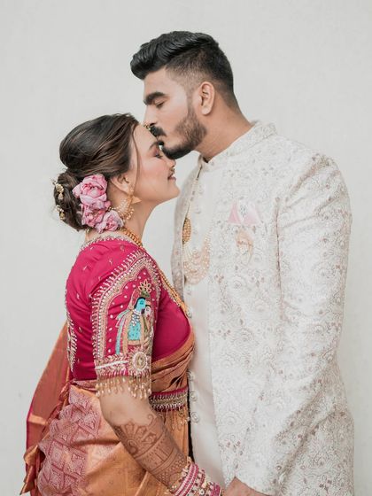 A match made in heaven. This couple shot showcases the bride's stunning look, with special attention to the intricate embroidery on her blouse.