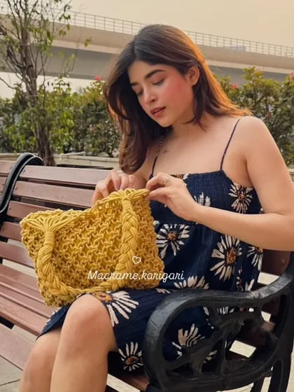 A candid shot with our macramé beach bag. It's spacious enough to hold everything you need for a day trip, from a book to your sunglasses.