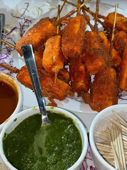 A platter of our crispy fried Paneer Tikka, served with traditional green chutney and tangy tamarind chutney. This is a perfect appetizer to get any party started.