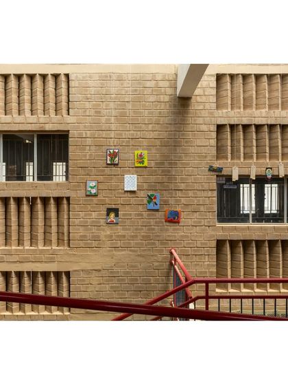 A detail of the CSEB wall at Buddhi School, where vertical brick fins act as a jali screen. This feature allows for constant air circulation while preventing harsh glare, a simple and effective passive design technique.