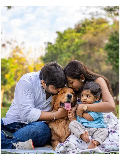 This is what pure happiness looks like. A beautiful family enjoying a sunny day in the park, with their golden retriever Scotch right in the middle of the group hug. My goal is to capture this casual, fun, and warm chaos that makes your family unique.