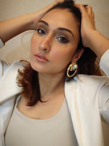 Here I am modeling the gorgeous brass hoop earrings with a crystal element. They are perfect for adding a touch of drama to a simple blazer look.