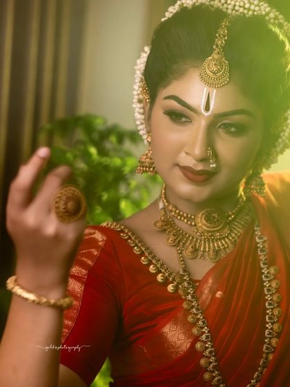 A series dedicated to capturing a divine, traditional look in a striking red saree. These images, shot both in-studio and outdoors, focus on graceful poses and the vibrant color of the attire.