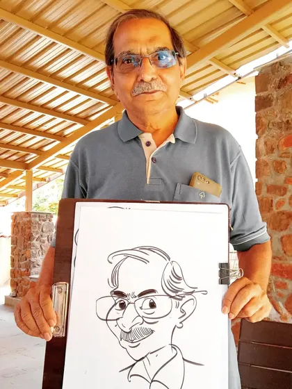A guest holding his caricature, which I drew for him at an outdoor event.