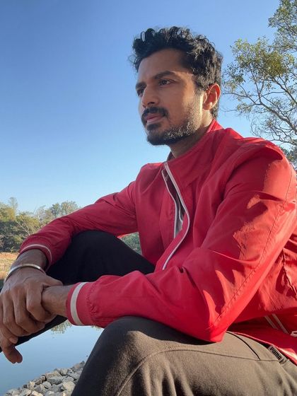 Enjoying a quiet moment by the lake. This shows my love for nature and a more contemplative side.